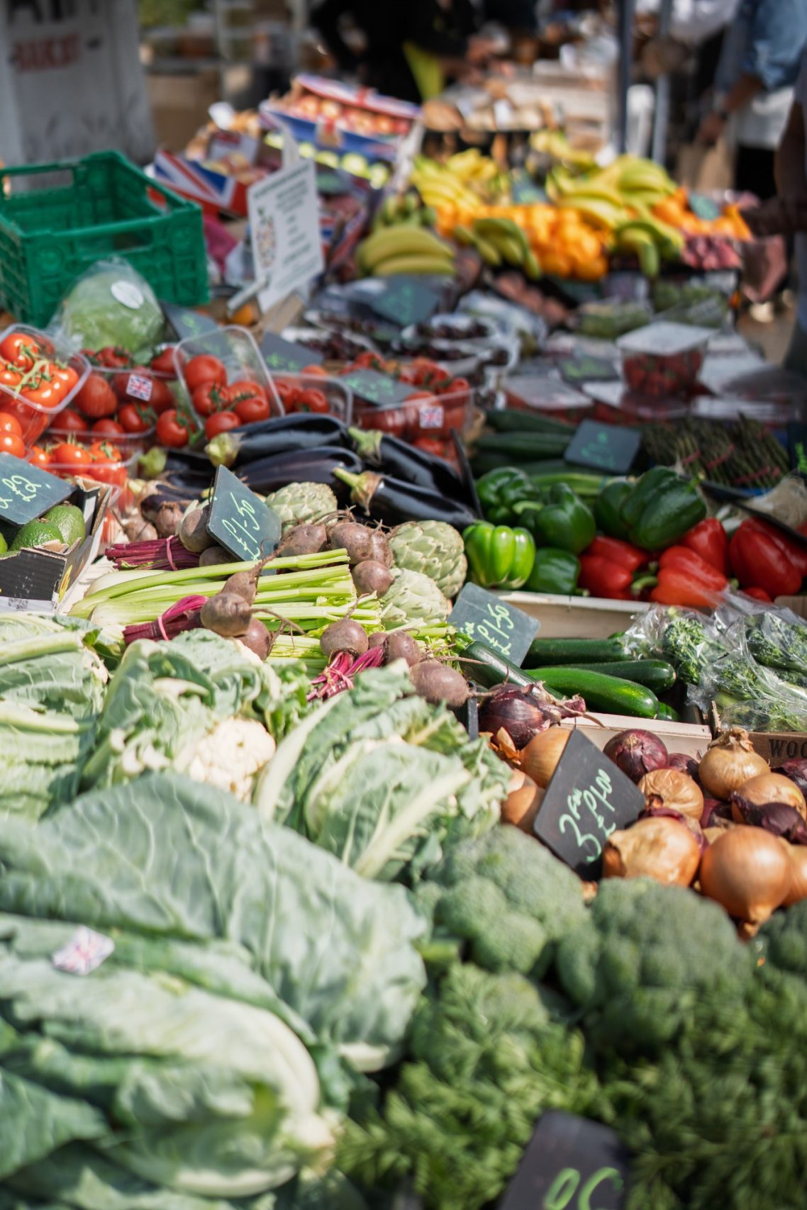 Colourful selection of fresh vegetables at a market stall.
